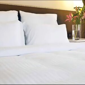 Hotel Bed Sheet white Twill T250 CottonPoly Satin Stripe on a bed